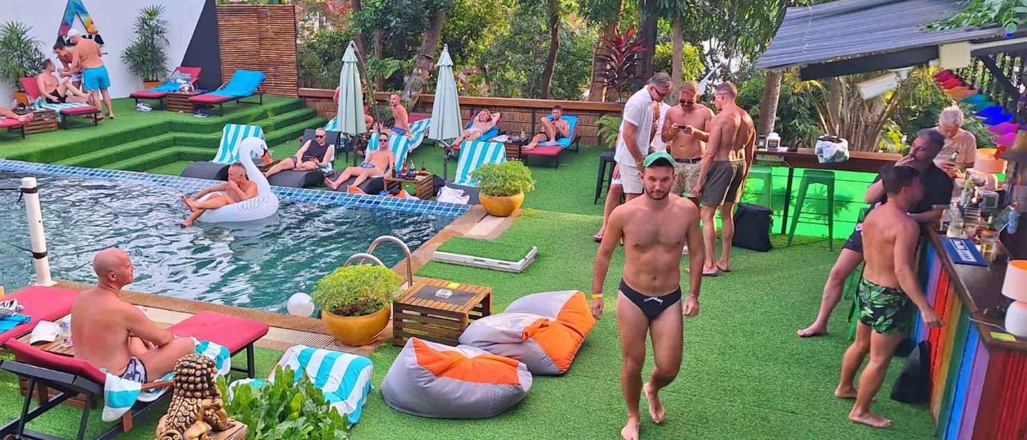 A group of gay men chillout poolside at Alpha Gay Resort, Koh Samui.